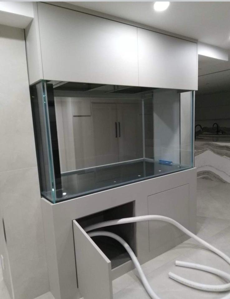 Modern white cabinet aquarium installation in progress - custom fish tank Brooklyn NY